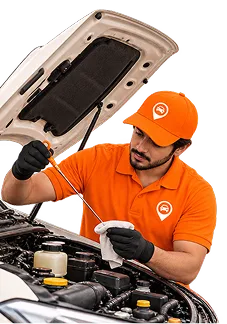 Mechanic inspecting engine oil level with dipstick